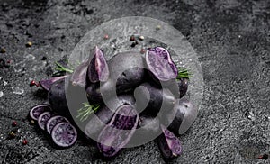 Raw sweet potatoes on dark background, Organic purple sweet potato. Raw sweet potatoes or batatas. pomoea batatas. Batata potato,