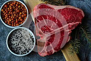 Raw T-bone or porterhouse steak with seasonings