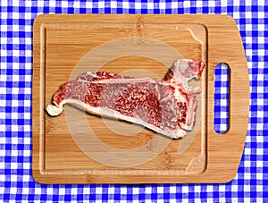 Raw T-bone steak on cutting table