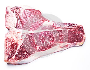 Raw T-bone steak on the white background.