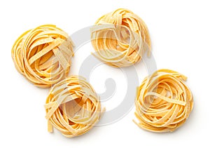 Raw Tagliatelle Pasta Nests Isolated On White Background