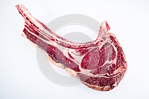 Raw tomahawk bone-in rib beef steak on white