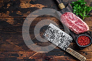 Raw Top Blade beef meat steak. Dark wooden background. Top view. Copy space