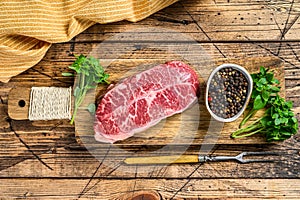 Raw Top Blade beef meat steak. wooden background. Top view