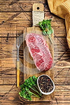 Raw Top Blade beef meat steak. wooden background. Top view