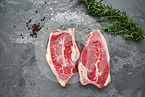 Raw Top-Blade steak dry-aged on stone background