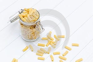 Raw tortiglioni pasta on a glass jar