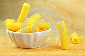 Raw tortiglioni pasta in a small bowl