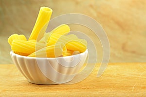 Raw tortiglioni pasta in a small bowl