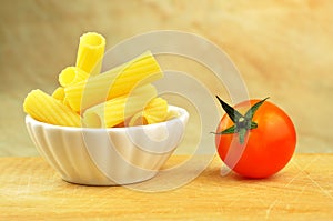 Raw tortiglioni pasta in a small bowl