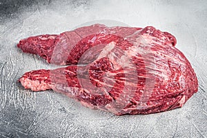 Raw tri tip beef steak on kitchen table. White background. Top view
