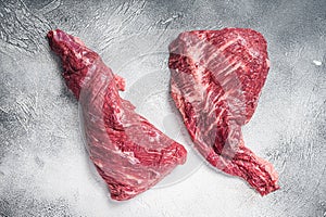 Raw tri tip beef steak on kitchen table. White background. Top view