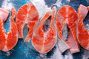 Raw trout steaks on salt. Fresh seafood ingredient. Cooking red fish.
