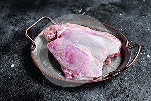 Raw Turkey boneless and skinless thigh fillet. Farm eco meat. Black background. Top view