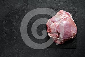 Raw Turkey thigh fillet. Farm eco meat.  Dark background. Top view. Space for text photo