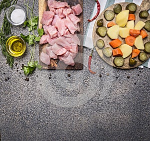 Raw turkey with tomato sauce, pepper, spices, herbs ingredients for stew on wooden rustic background top view close up border ,pl