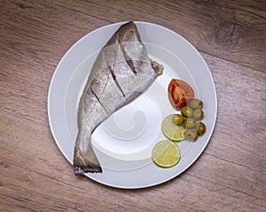 Raw uncooked fish on plate