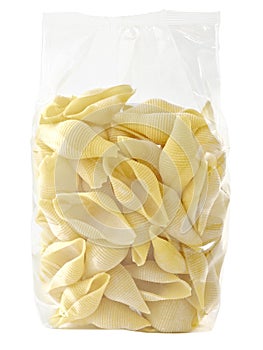 Raw uncooked italian conchiglie jumbo shell pasta in plastic bag