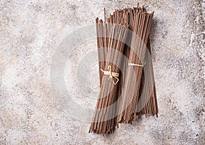 Raw uncooked Japanese soba noodles on light bacground