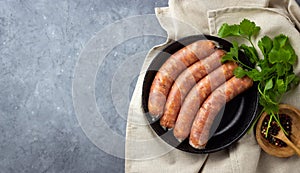 Raw uncooked meat sausages and green herbs