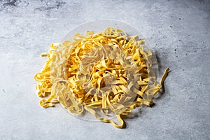 Raw uncooked pasta on a gray background