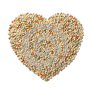 Raw uncooked pearl couscous tricolore in heart shape isolated on white background