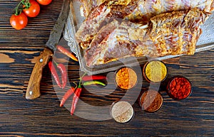 Raw uncooked rack of lamb on wooden chopping board