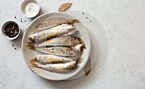 Raw uncooked  red mullets on gray background
