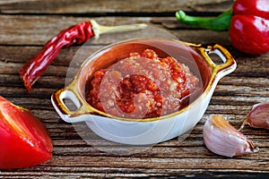 Raw uncooked Salsa or adjika sauce is traditional Mexican or Caucasus Armenian sauce with tomatoes and hot chili peppers