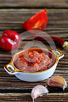 Raw uncooked Salsa or adjika sauce traditional Mexican or Caucasus Armenian sauce with tomatoes and hot chili peppers on