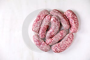 Raw uncooked sausages salsiccia nodi photo