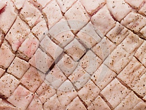 Raw uncooked seasoned scored pork belly skin background