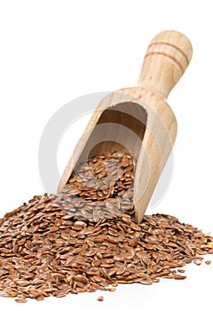 Raw, unprocessed linseed or flax seed in wooden scoop