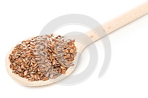 Raw, unprocessed linseed or flax seed in wooden spoon