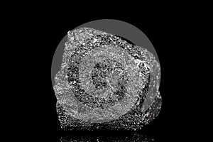 Raw and unrefined silicon element in front of black background photo