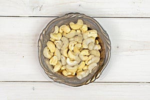 Raw unsalted cashew on grey wood