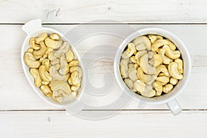 Raw unsalted cashew on grey wood