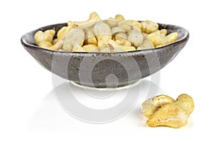 Raw unsalted cashew isolated on white
