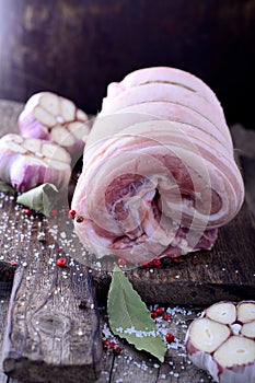 Raw veal meat roast roll on wooden cutting board