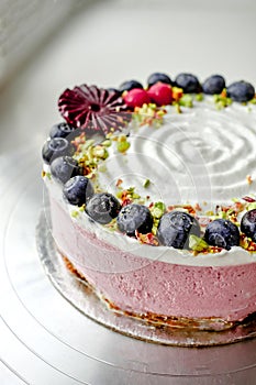 Raw vegan blueberry cake decorated with berry. Strawberry filling jelly vegetarian cashew cream cheesecake gluten free