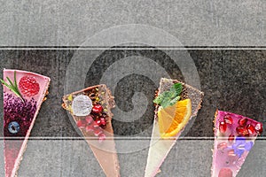 Raw vegan cakes with fruit and seeds, decorated with flower, product photography for patisserie