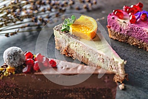 Raw vegan cakes with fruit and seeds, decorated with flower, product photography for patisserie