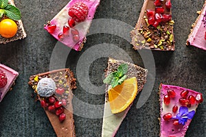 Raw vegan cakes with fruit and seeds, decorated with flower, product photography for patisserie