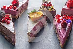 Raw vegan cakes with fruit and seeds, decorated with flower, product photography for patisserie