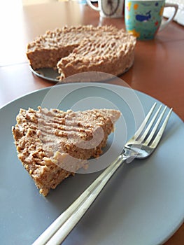 Raw vegan chickpeas blondies cake on blue plate. Close up vegetarian dessert coconut carrot protein diet. Sugar free