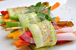 Raw , vegan meal with cucumber, pepper, onion and carrot