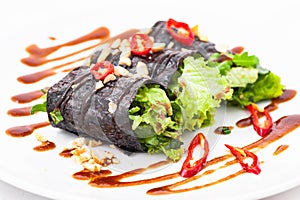 Raw vegan nori hand rolls with sauce, salad and vegetables. Vegetarian, gluten-free food
