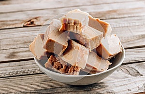 Raw vegan peanut butter fudge on a rustic wooden background