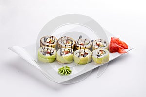 Raw vegan sushi rolls with cucumber and tomato isolated on white background