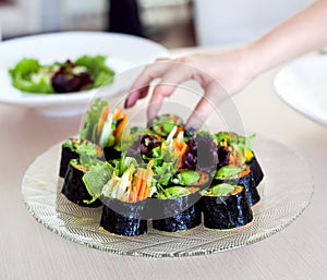 Raw vegan sushi rolls with vegetables